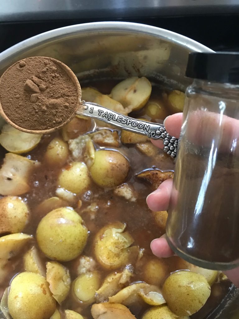 adding cloves to make pear sauce