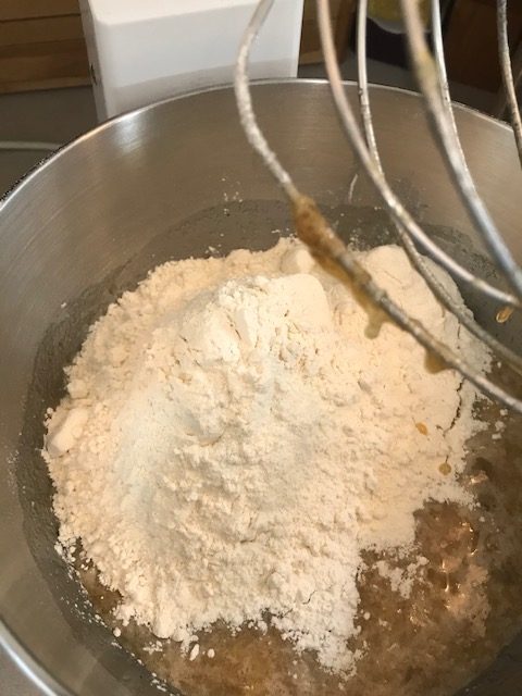 adding flour to banana bread