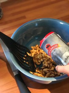 adding salt to pumpkin seeds