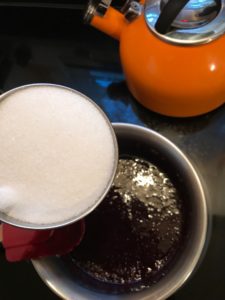 adding sugar to currant jelly