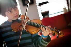 boy practicing on an instrument 