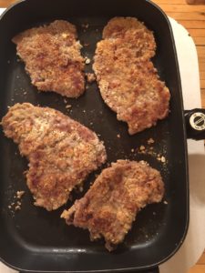 cube steak frying in pan