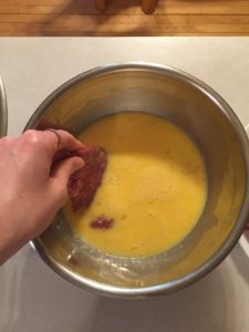 Dipping steak in egg batter