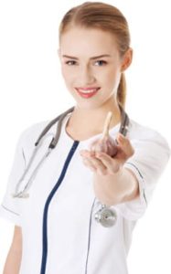 doctor holding a clove of garlic