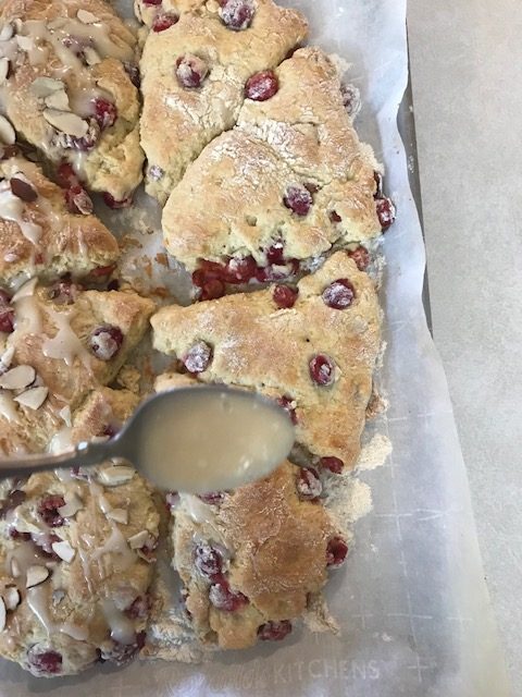 glaze drizzled over cherry scones