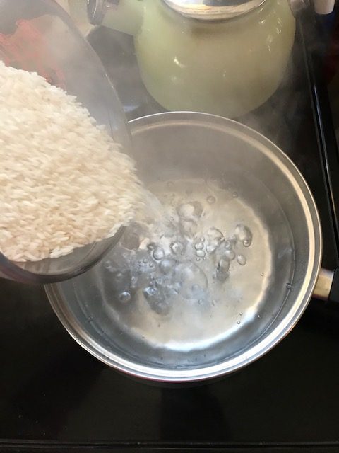 dumping rice into boiling water