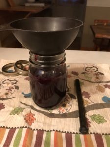filling a jar with crandall currant jelly