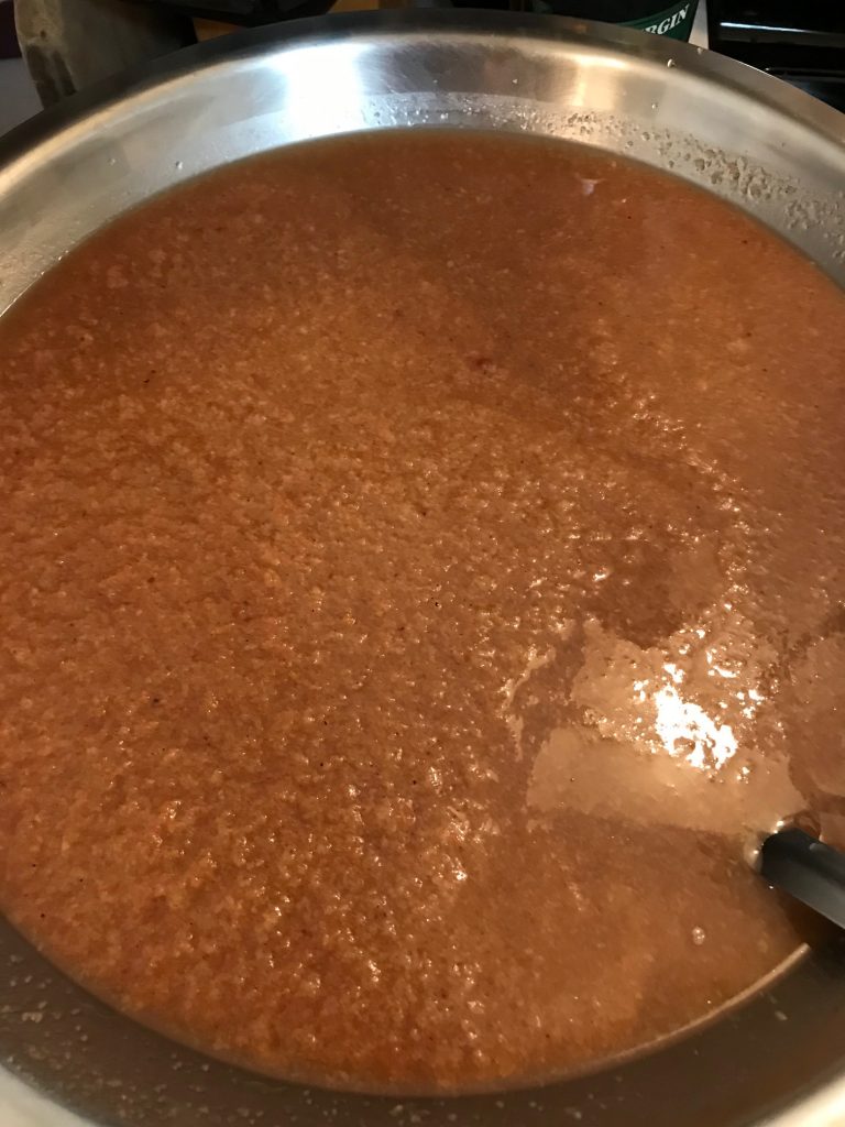heating pear pulp and juice to make sauce and cider