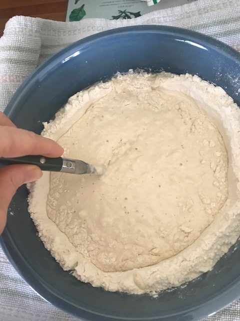 stirring yeast mixture into flour