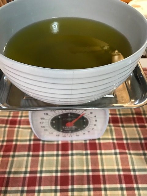 Measuring olive oil to make lye soap