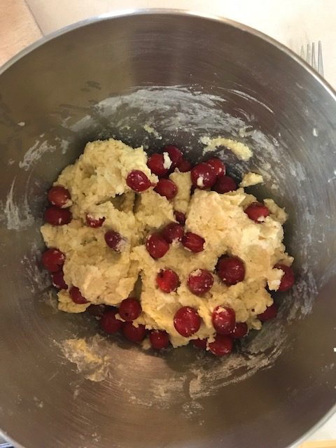 mixing the cherries into the dough