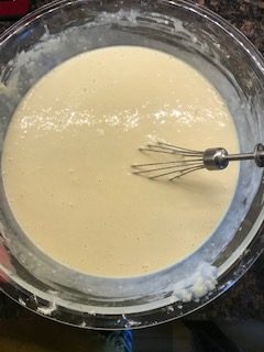 mixing the wet ingredients with the dry for waffles