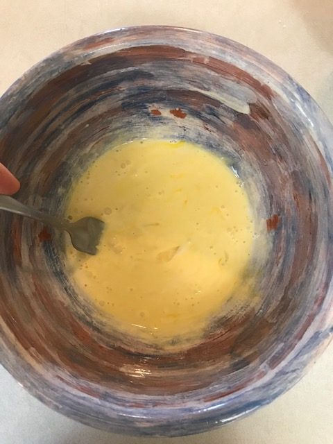 mixing the egg, heaving cream, and vanilla