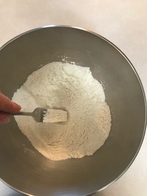mixing the flour, sugar, baking powder, and salt