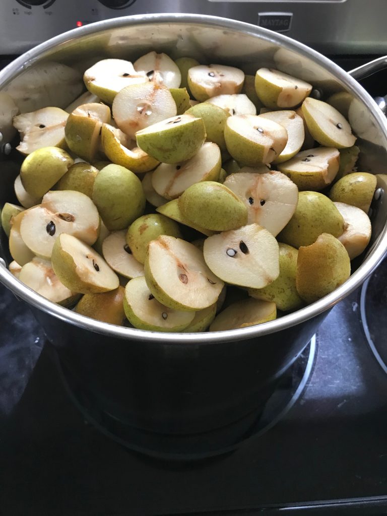 halved pears in a pot
