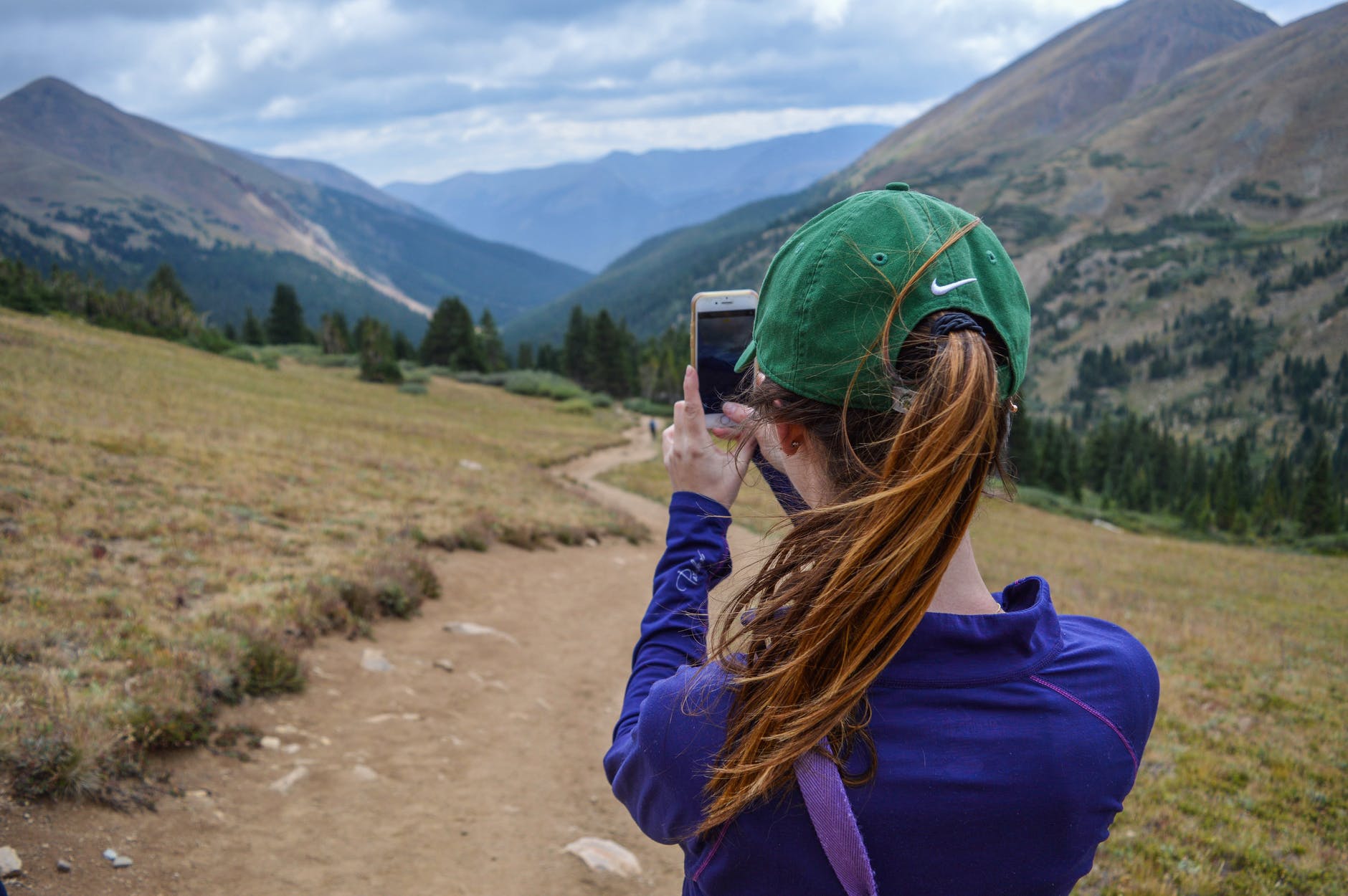 woman taking photo of mountain