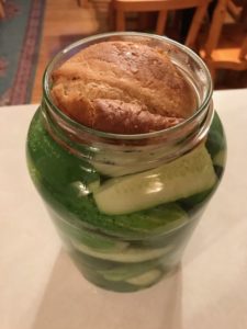slice of bread on top of dill pickles