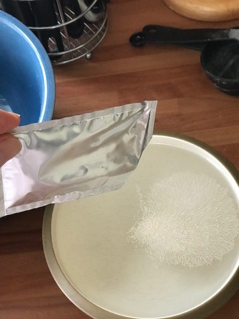 pouring yeast into water