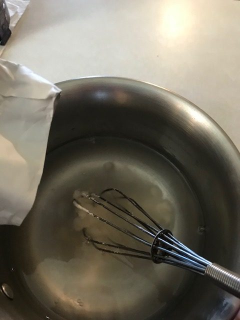pouring pectin into 3/4 cup of cold water