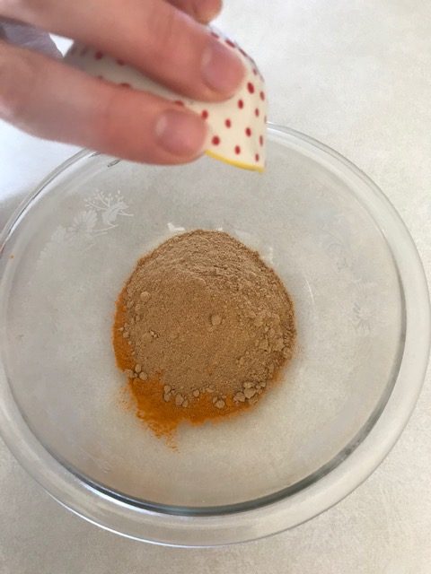 pouring ginger into bowl for capsules