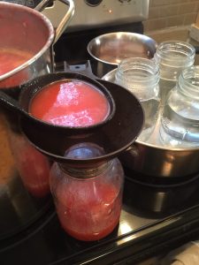 ladling soup into hot jars