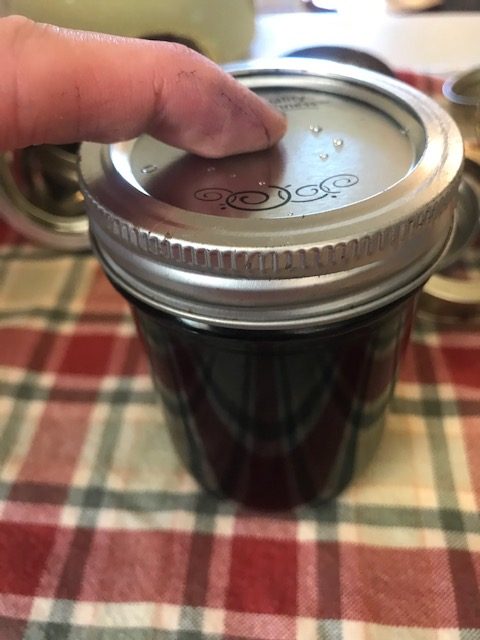 putting the lid and ring on the jar