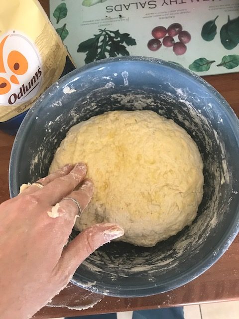 Rubbing Sicilian bread dough with olive oil