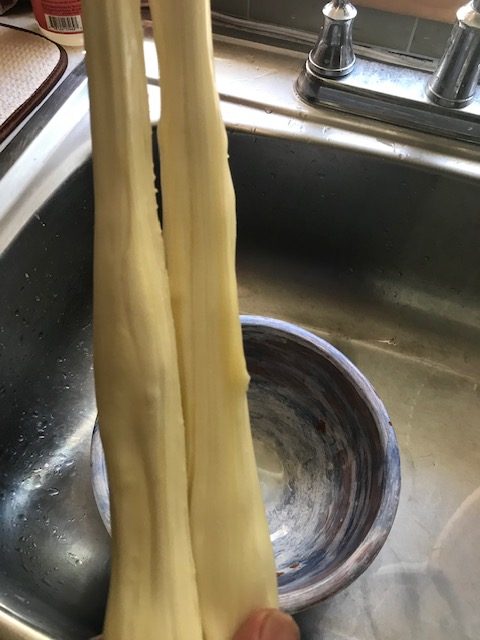 stretching the mozzarella cheese
