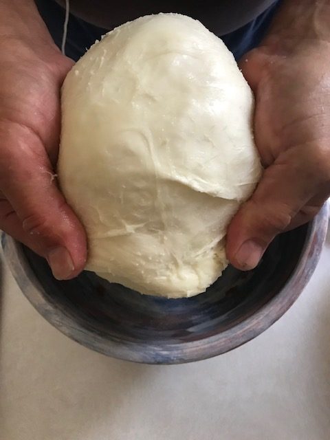 removing the whey from the mozzarella cheese